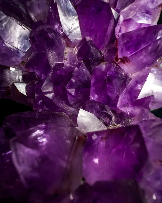 A bunch of purple crystals sitting on top of a table